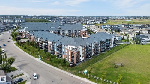 Contemporary multi-story residential buildings featuring balconies and a consistent architectural style - #131 5504 Schonsee Dr Nw, Edmonton, AB - Outdoor With View