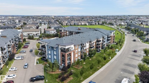 Multi-story residential buildings with shingle roofs and private balconies - #131 5504 Schonsee Dr Nw, Edmonton, AB - Outdoor With View