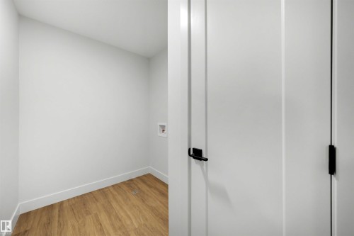 Laundry hookups with wood-finish flooring - 16 Grayson Green, Stony Plain, AB - Indoor Photo Showing Other Room