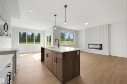 Kitchen island with a built-in sink and pendant lighting - 