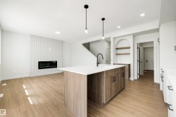 Spacious open-concept living area with wood-finish flooring - 