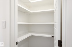 White built-in shelving providing ample storage - 