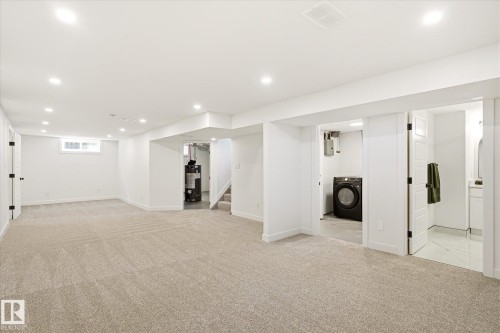 Spacious lower level featuring plush carpeting, recessed lighting, and a window for natural light - 4708 104A Avenue Nw, Edmonton, AB - Indoor