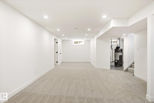 Finished lower level featuring recessed lighting, light-toned carpet, white walls, and a small window - 4708 104A Avenue Nw, Edmonton, AB - Indoor Photo Showing Other Room