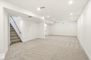 Spacious room featuring light-toned carpet flooring, white walls, and recessed lighting - 4708 104A Avenue Nw, Edmonton, AB  - Indoor Photo Showing Other Room 