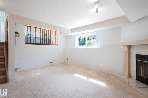 435 Ormsby Road Nw, Edmonton, AB - Indoor Photo Showing Other Room With Fireplace