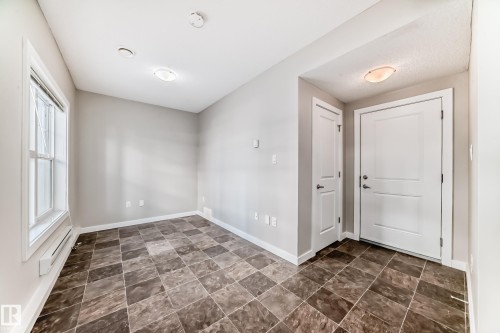Tiled flooring, white trim, window with muntins, and overhead lighting - #75 2803 James Mowatt Tr Sw, Edmonton, AB 