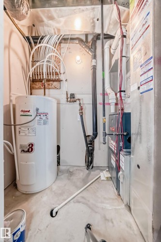 Water heater and furnace with exposed plumbing and ductwork - #75 2803 James Mowatt Tr Sw, Edmonton, AB 
