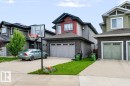 Multi-level home with a two-car garage, stone-finish siding, and a concrete driveway - 527 Merlin Landing Nw, Edmonton, AB  - Outdoor 