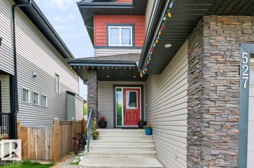 Multi-textured facade featuring horizontal siding and stone accents - 527 Merlin Landing Nw, Edmonton, AB - Outdoor
