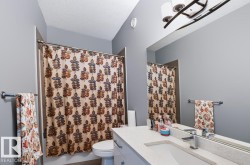 Single vanity with an integrated rectangular sink, chrome-finish faucet, and a large wall-mounted mirror - 