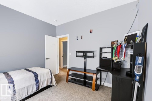Neutral wall paint, light-colored carpeting, white interior door, and integrated ceiling lighting - 527 Merlin Landing Nw, Edmonton, AB - Indoor Photo Showing Bedroom