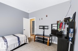 Neutral wall paint, light-colored carpeting, white interior door, and integrated ceiling lighting - 