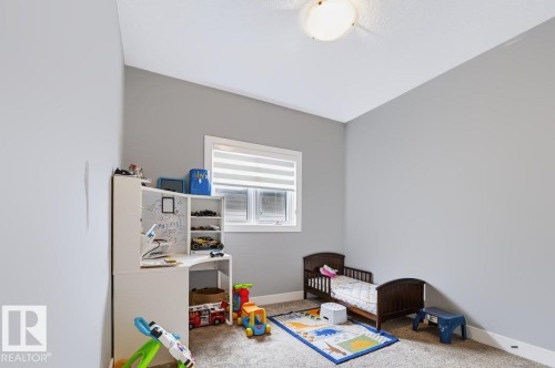 Window with horizontal blinds, flush mount ceiling light, light gray wall paint, and gray carpet flooring - 527 Merlin Landing Nw, Edmonton, AB - Indoor