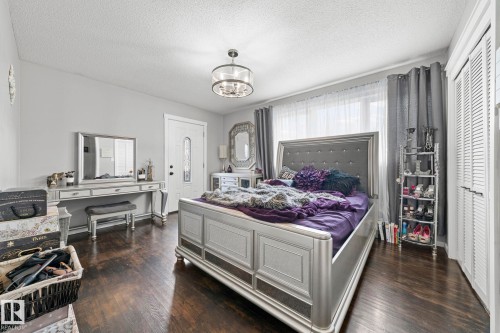 Dark wood-finish flooring - 11119 31St Nw Nw, Edmonton, AB - Indoor Photo Showing Bedroom