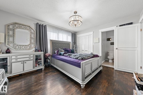 Recessed lighting, wood-finish flooring, and built-in closet with louvered doors - 11119 31St Nw Nw, Edmonton, AB - Indoor Photo Showing Bedroom