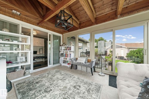 Enclosed sunroom with a wood plank ceiling and exposed beams - 11119 31St Nw Nw, Edmonton, AB - 
