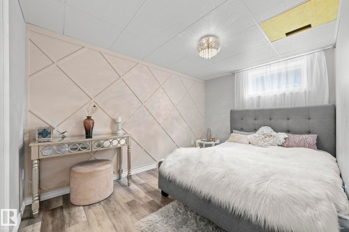 Custom accent wall with geometric paneling - 11119 31St Nw Nw, Edmonton, AB - Indoor Photo Showing Bedroom