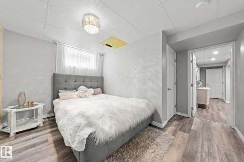 Wood-finish flooring, recessed lighting, and a neutral color palette - 11119 31St Nw Nw, Edmonton, AB - Indoor Photo Showing Bedroom