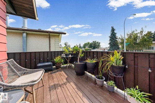 Outdoor deck with wood-finish flooring and a dark wood privacy fence - 11119 31St Nw Nw, Edmonton, AB - Outdoor With Deck Patio Veranda With Exterior