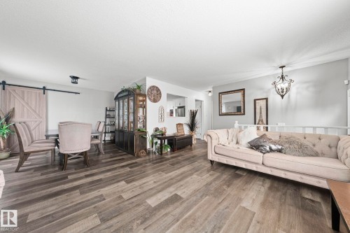 Wood-finish flooring throughout - 11119 31St Nw Nw, Edmonton, AB - Indoor Photo Showing Living Room