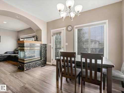 153 Kulawy Drive Nw, Edmonton, AB - Indoor Photo Showing Dining Room With Fireplace