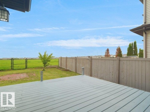 Expansive backyard featuring a composite deck, mature tree, and privacy fencing - 3010 17A Ave Nw, Edmonton, AB - Outdoor