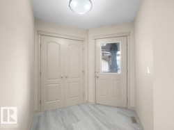 Wood-finish flooring, paneled doors, and a ceiling-mounted light fixture - 