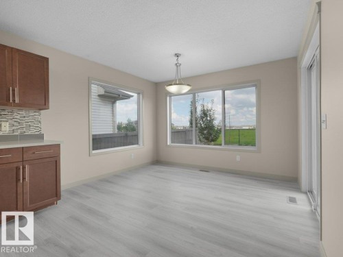 Light wood-finish flooring with a neutral wall color - 3010 17A Ave Nw, Edmonton, AB - Indoor