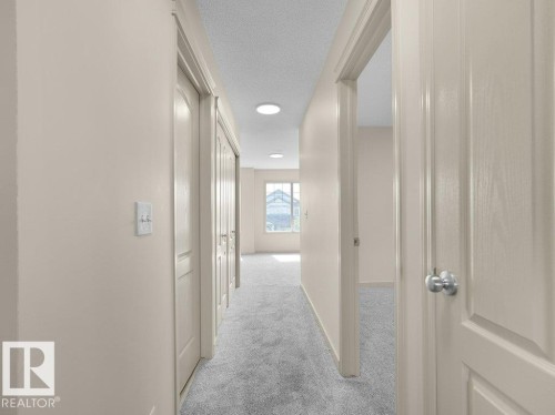 Hallway with recessed lighting, light-toned walls, and grey carpet flooring - 3010 17A Ave Nw, Edmonton, AB - Indoor Photo Showing Other Room