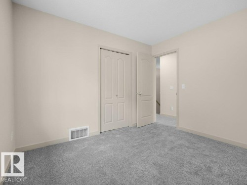 Neutral paint palette, textured carpet flooring, interior panel doors, and trim detailing - 3010 17A Ave Nw, Edmonton, AB - Indoor