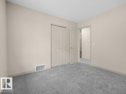 Neutral paint palette, textured carpet flooring, interior panel doors, and trim detailing - 