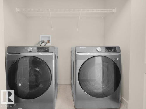 Laundry area with tile flooring and a white wire shelf - 3010 17A Ave Nw, Edmonton, AB - Indoor Photo Showing Laundry Room