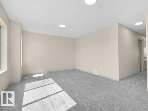 Light beige wall paint, plush gray carpeting, recessed ceiling lighting, and white window trim - 3010 17A Ave Nw, Edmonton, AB - Indoor Photo Showing Other Room