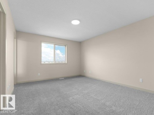 Neutral tone wall paint, window with white trim, recessed ceiling light, grey carpeting, and light-colored baseboards - 3010 17A Ave Nw, Edmonton, AB - Indoor Photo Showing Other Room