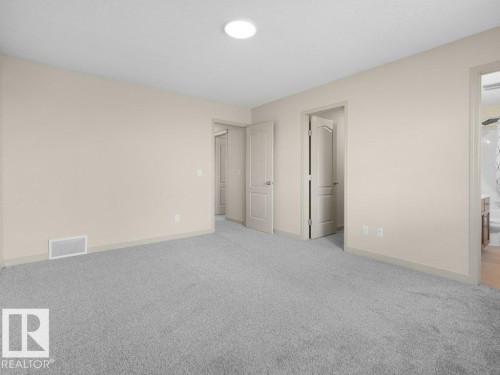 Neutral-toned walls complement the light gray carpeting - 3010 17A Ave Nw, Edmonton, AB - Indoor Photo Showing Other Room