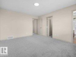 Neutral-toned walls complement the light gray carpeting - 