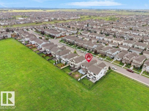 Residential property featuring a two-story design with a fenced backyard, and a paved street - 3010 17A Ave Nw, Edmonton, AB - Outdoor With View