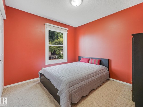 Wall-to-wall carpeting, single window with white trim, white ceiling with flush-mount lighting, and white interior door - 18417 66 Avenue Nw, Edmonton, AB - Indoor Photo Showing Bedroom