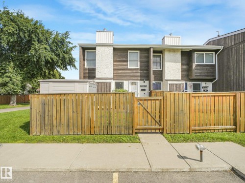 Townhome exterior with wood siding and stucco accents - 18417 66 Avenue Nw, Edmonton, AB - Outdoor