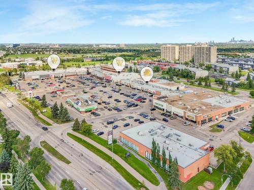 Retail commercial district with multiple buildings and extensive paved parking - 18417 66 Avenue Nw, Edmonton, AB - Outdoor With View