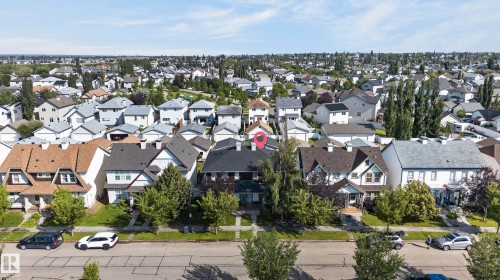 Residential property with a dark shingle roof, light-colored siding, and mature front landscaping - 6008 South Terwillegar Boulevard Nw, Edmonton, AB - Outdoor