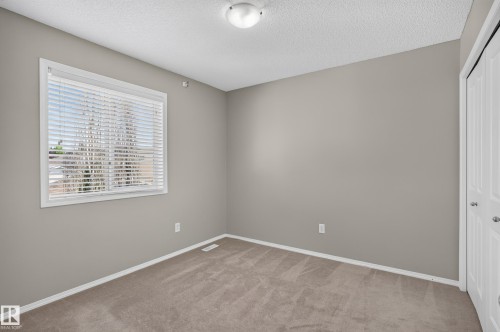 Wall-to-wall carpeting, window with blinds, bi-fold closet doors, and flush-mount ceiling light - 6008 South Terwillegar Boulevard Nw, Edmonton, AB - Indoor Photo Showing Other Room