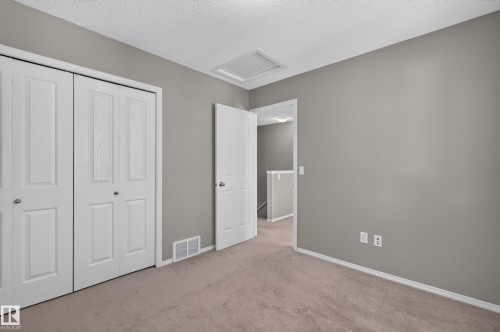 Soft gray wall finish, neutral carpet, white trim, and a white paneled door - 6008 South Terwillegar Boulevard Nw, Edmonton, AB - Indoor Photo Showing Other Room