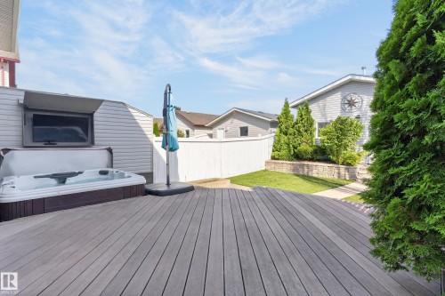 Expansive deck with a built-in hot tub and outdoor television - 6008 South Terwillegar Boulevard Nw, Edmonton, AB - Outdoor With Deck Patio Veranda With Exterior