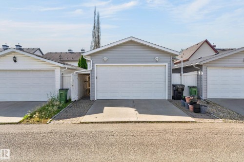 Attached garage with light grey siding, white garage door, and a concrete driveway - 6008 South Terwillegar Boulevard Nw, Edmonton, AB - Outdoor