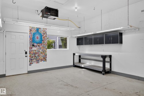 Concrete flooring, built-in wall cabinets, and an overhead heater - 6008 South Terwillegar Boulevard Nw, Edmonton, AB - Indoor Photo Showing Other Room