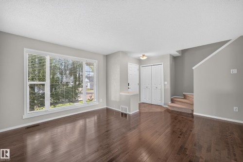 Bright living space flooded with natural light through expansive multi-pane windows with plantation shutters - 6008 South Terwillegar Boulevard Nw, Edmonton, AB - Indoor Photo Showing Other Room