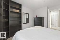 Built-in shelving unit, neutral wall color, and light-toned carpet - 