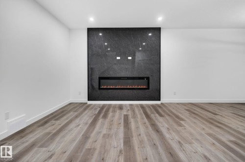 13 Enns Crest, Fort Saskatchewan, AB - Indoor Photo Showing Other Room With Fireplace